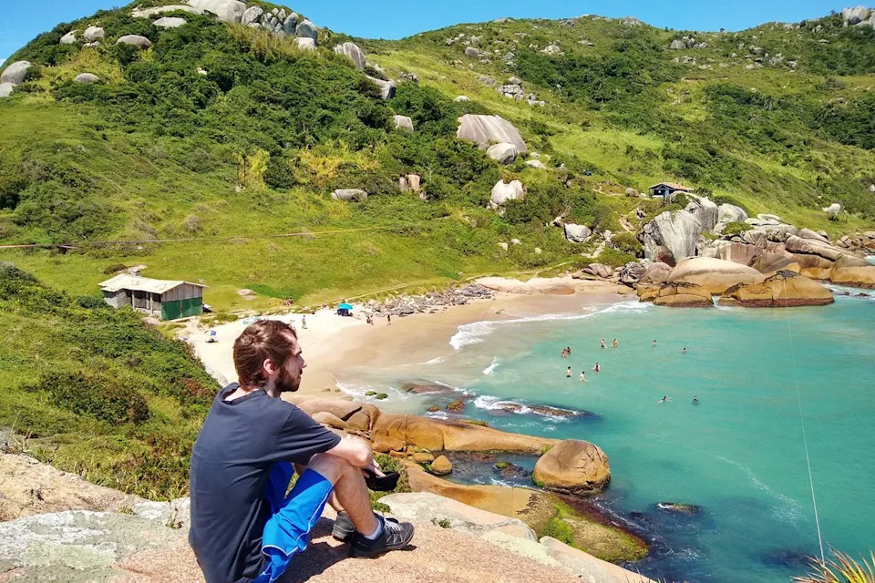 Maiquel Jantsch/Getty Images Man overlooking a beach in Florianpolis, Brazil.