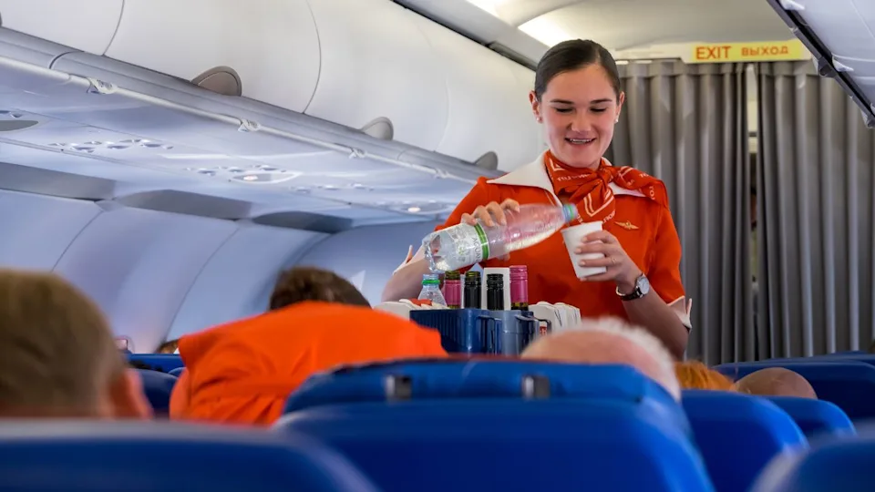 Central Federal District, Russian Federation - august 31, 2019: Stewardess of a Russian company serving passengers on a plane bound for Sheremetyevo Airport, Moscow City