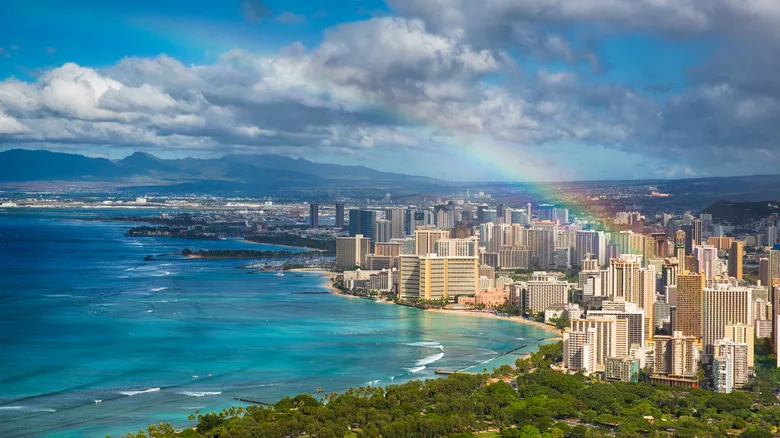 An aerial view of Honolulu with a rainbow