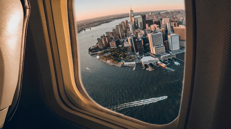 Airplane flying past Manhattan