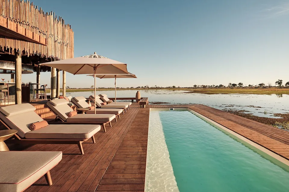 Baines' Lodge, an A&K Sanctuary Lounge chairs lay around the infinity pool.