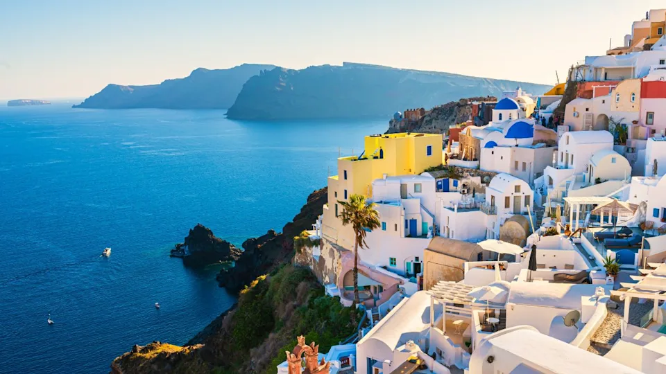 White architecture in Santorini island, Greece. Beautiful view of Oia town at sunset. Travel and vacation concept