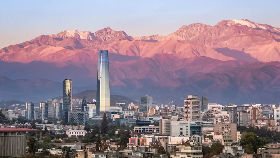 Aaerial view of Santiago skyline at sunset with Costanera skyscraper and Andes Mountains - Santiago, Chile