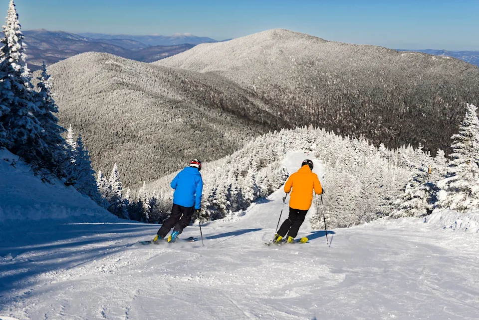The scene looking down Chilcoot, an intermediate cruiser on Madonna Mountain with sweeping mountain, lake and valley views.