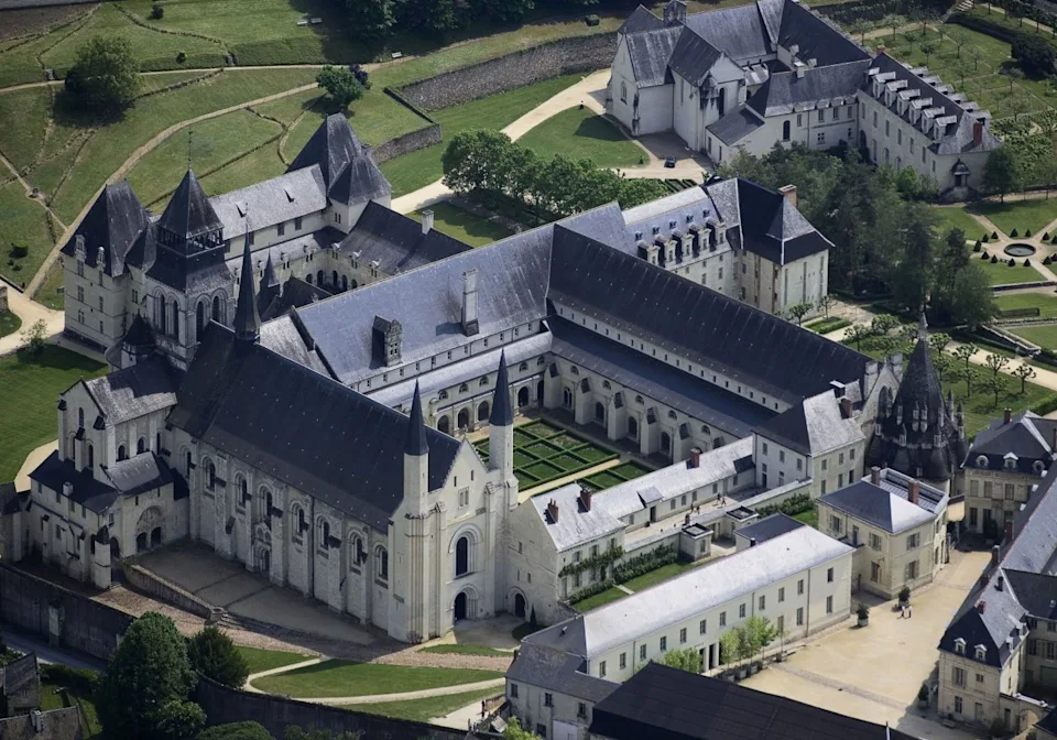 Aerial view of the Fontevraud L’Ermitage an imposing fortress-looking building with spires and pointed roofs. - Courtesy of the Fontevraud L'Ermitage