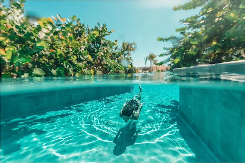 A woman swims in one of the many pool at Palmaïa, an all-inclusive vegan resort on the Rivera Maya in Mexico.