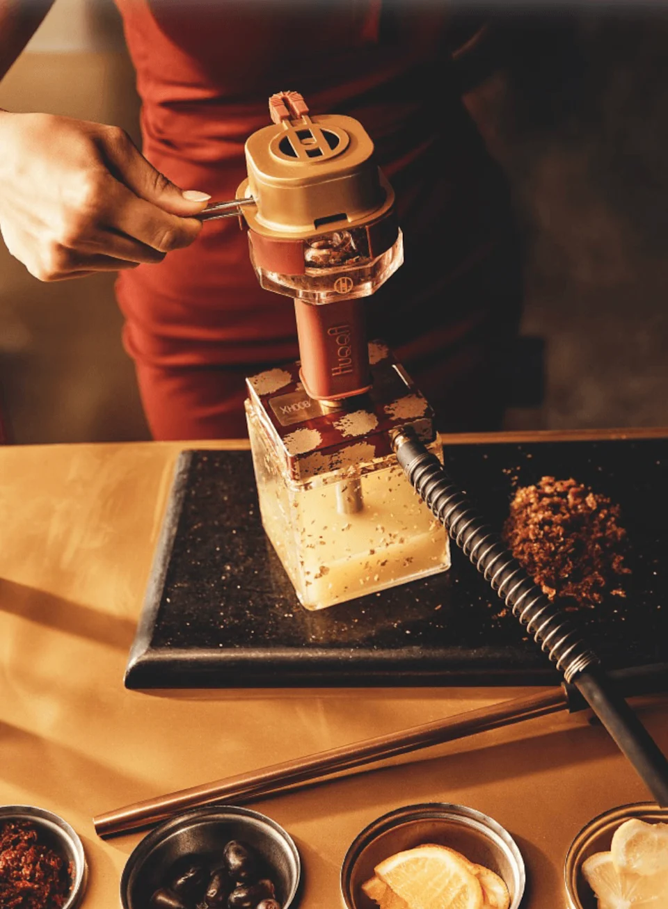 A sommelier at HuqqA preparing tobacco