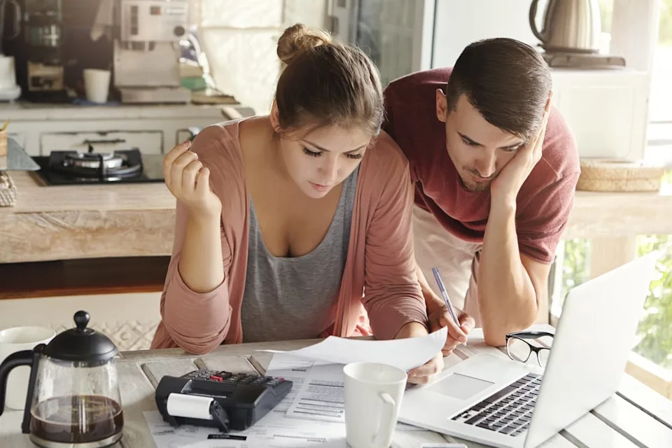 Young married couple with paperwork.