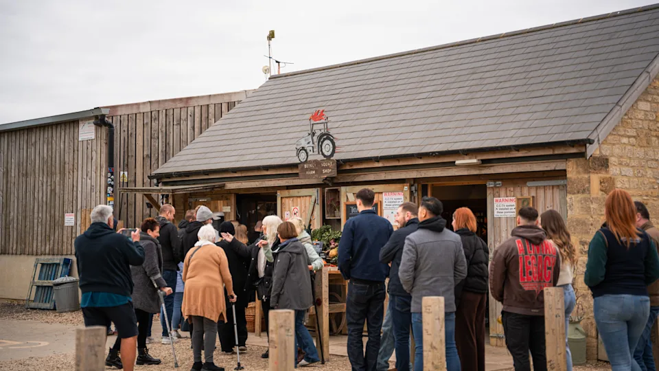 People line up at Diddly Squat Farm shop.