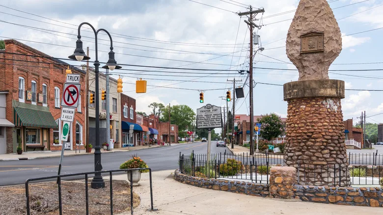 Buildings in downtown Old Fort with historical statue on display.