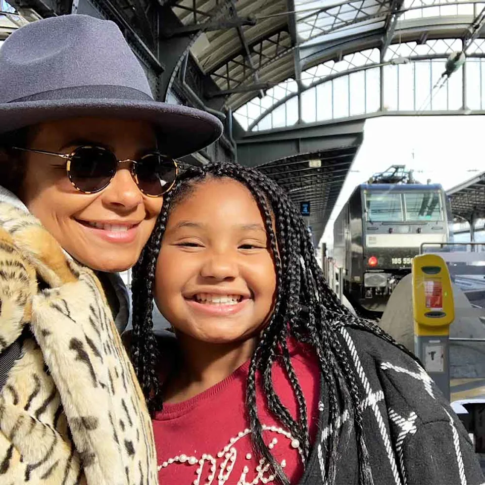 Christina Milian poses by a train 