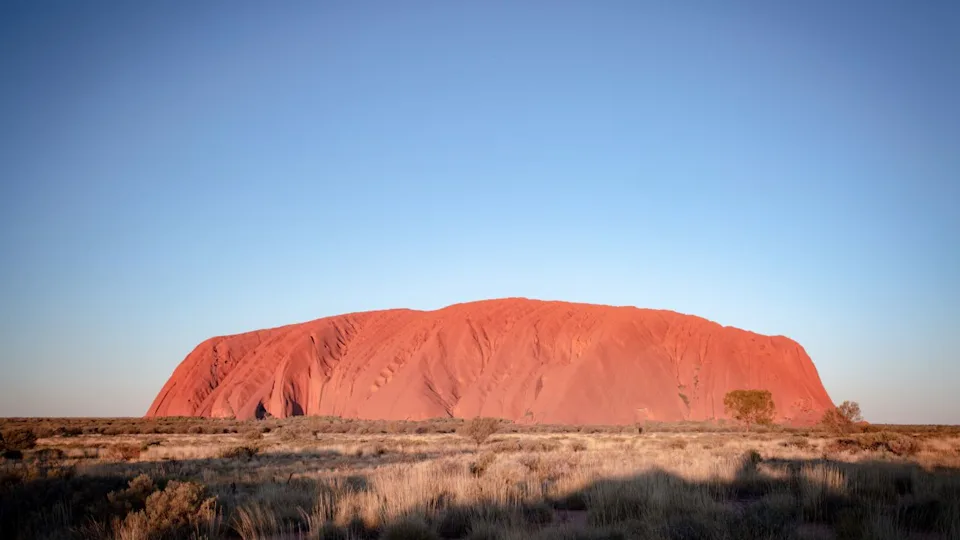 Uluru, Australia - July 4 2015: Majestic Uluru at sunset on a clear winter's evening in the Northern Territory, Australia
