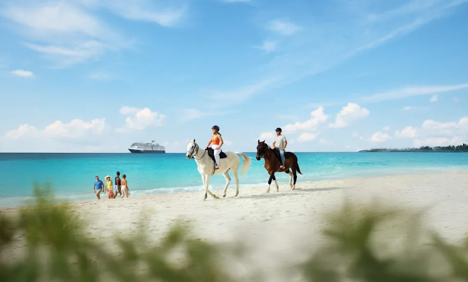holland america cruise ship in the caribbean with a beach and horseback riders in the foreground