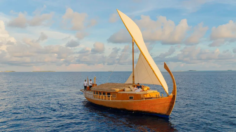 A couple enjoying a romantic cruise on a dhoni, a traditional Maldivian boat