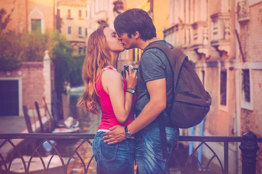 Couple kissing on vacation in Italy.