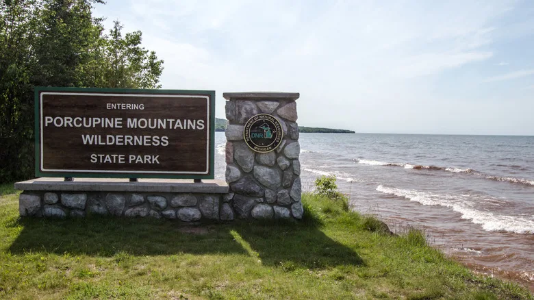 The "Entering Porcupine Moountains Wilderness State Park" sign next to Lake Superior.