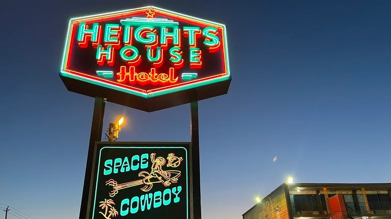 Bright neon sign announces Heights House Hotel