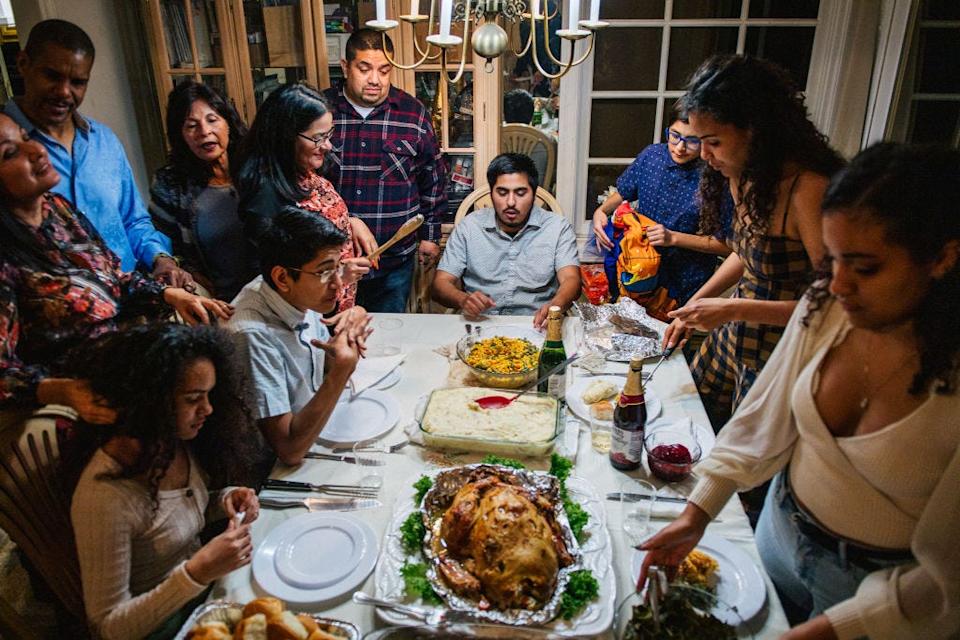 The Broughton family prepares for their dinner prayers during a gathering on Nov. 26, 2020 in Los Angeles, California.