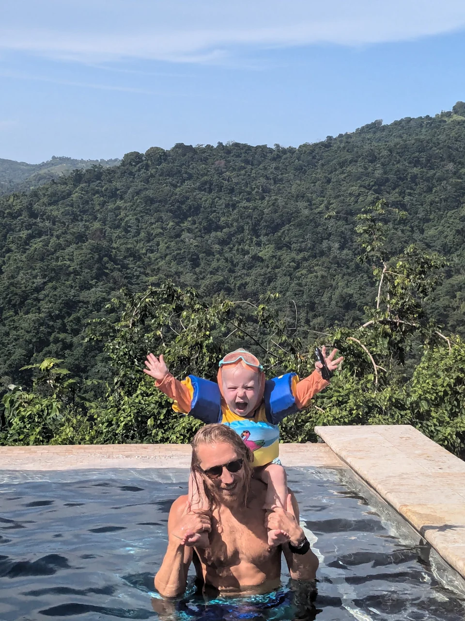 The author's husband and son enjoy a pool day in Puerto Rico.