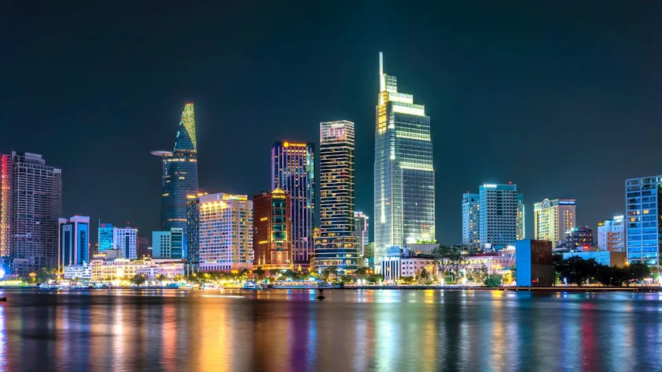 Ho Chi Minh City, Vietnam - April 7th, 2025: Ho Chi Minh City skyline and skyscrapers on Saigon river, center of heart business at downtown. Night view. Financial and business concepts
