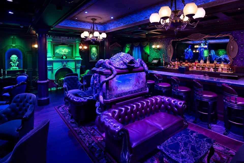 Disney Exclusive to Disney Cruise Line, the Haunted Mansion Parlor, which first debuted aboard the Disney Treasure in 2024, invokes inspiration from the original theme park attraction and invites guests to sip crafted cocktails among the happy haunts.