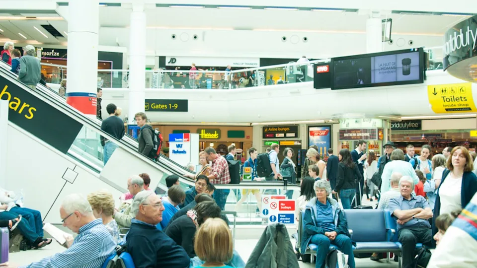 People in hall of Gatwick airport, England UK