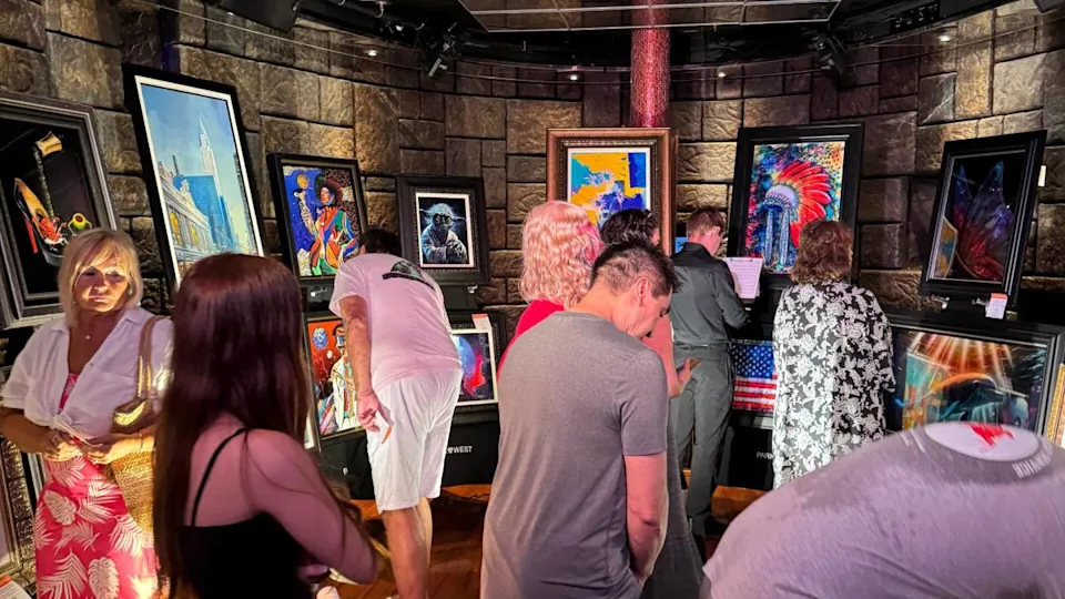 <em>Passengers preview artworks at sea before a Park West auction begins.</em>