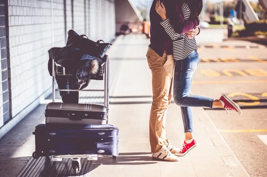 Couple hugging at the airport.