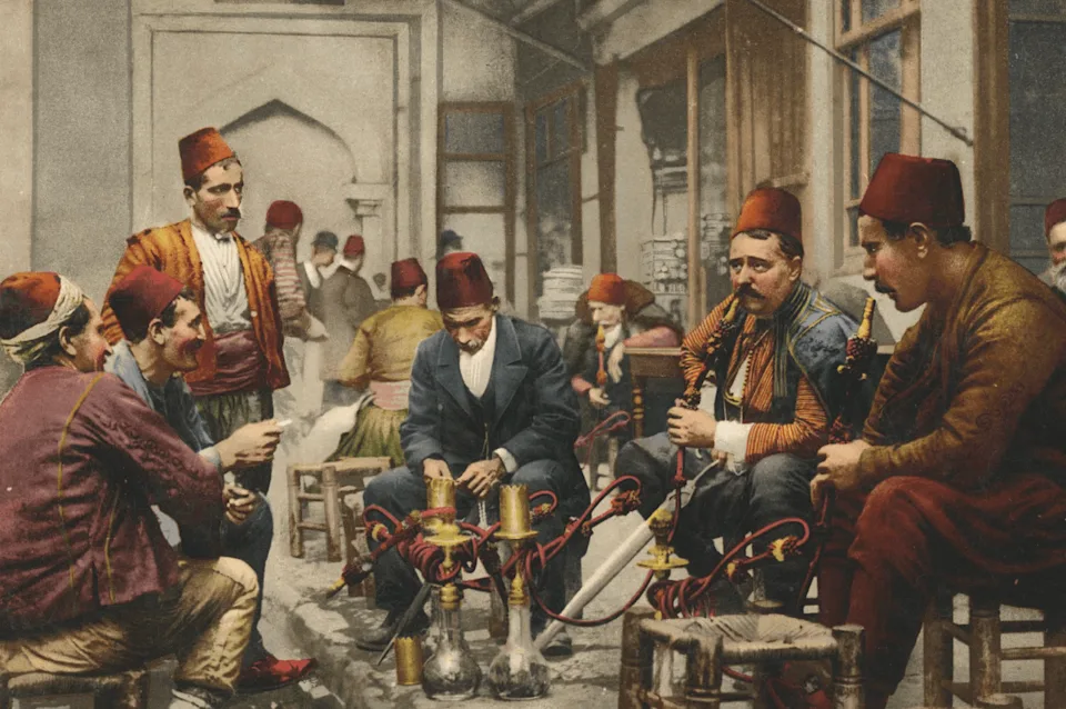 An 1897 print of hookah smokers in an Istanbul coffee house, sourced from Photoglob, Zurich, and featured in Assouline's new book, Mystic Mist: The Rituals of Huqqa.