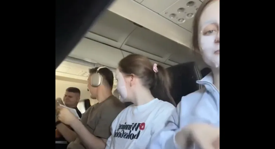 two women on a flight wearing spa-like facemarks and two passengers look on 