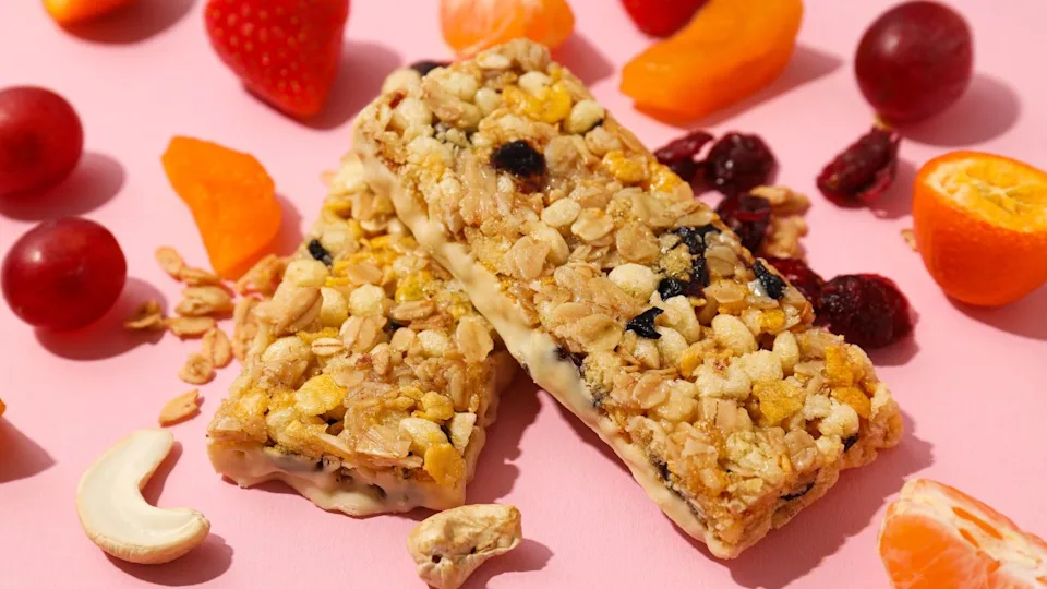 Granola bars with fruit on a pink background