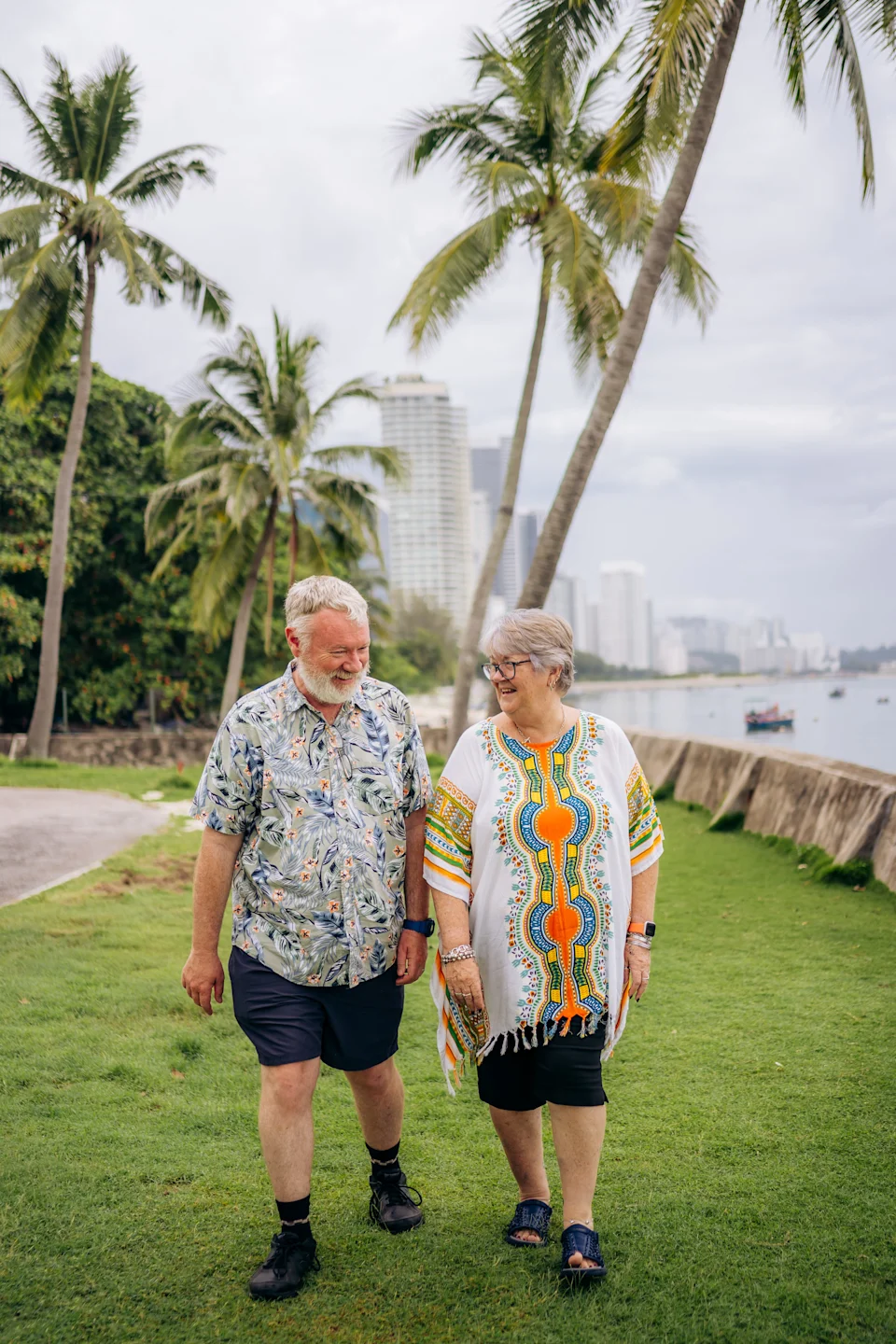 A couple walking along a park on the beach in Penang, Malaysia,