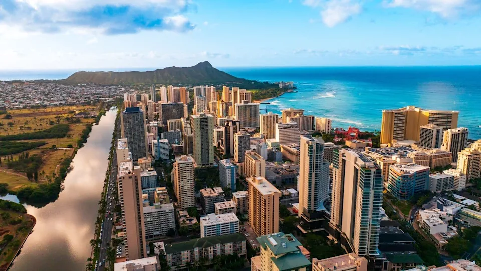 Modern high-rise downtown of Honolulu, Hawaii, USA. Diamond Head Crater at backdrop. Aerial view.