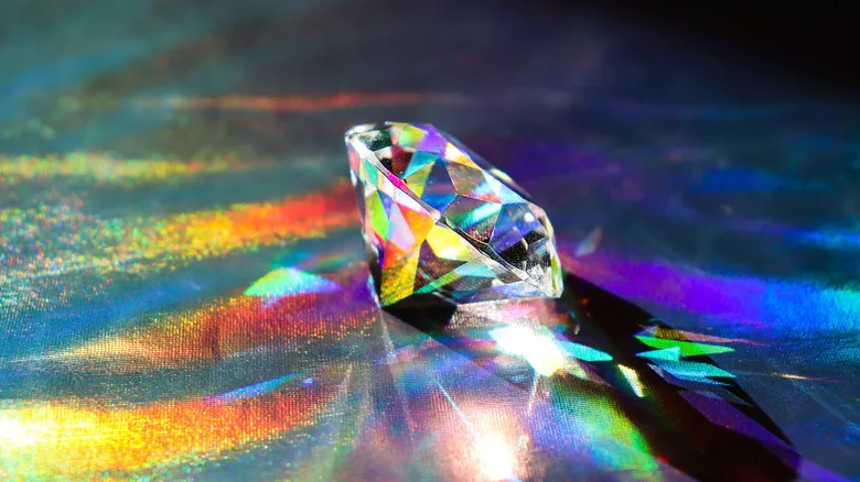 A diamond reflecting various colors through its facets