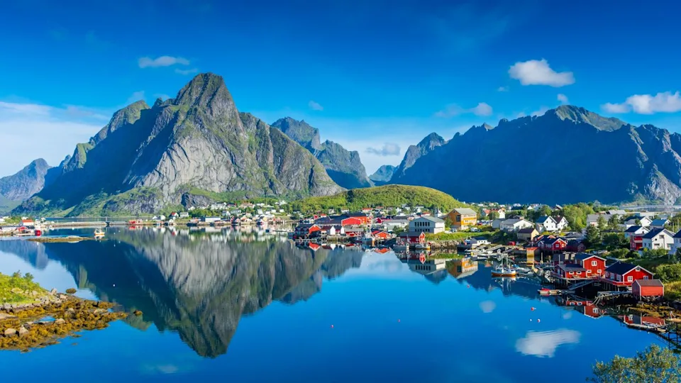 Perfect reflection of the Reine village on the water of the fjord in the Lofoten Islands, Norway