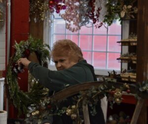 Butler’s Orchard employee works on a wreath