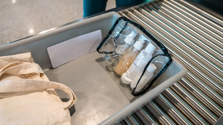 Bag of liquids in a gray bin on the conveyor belt at airport security