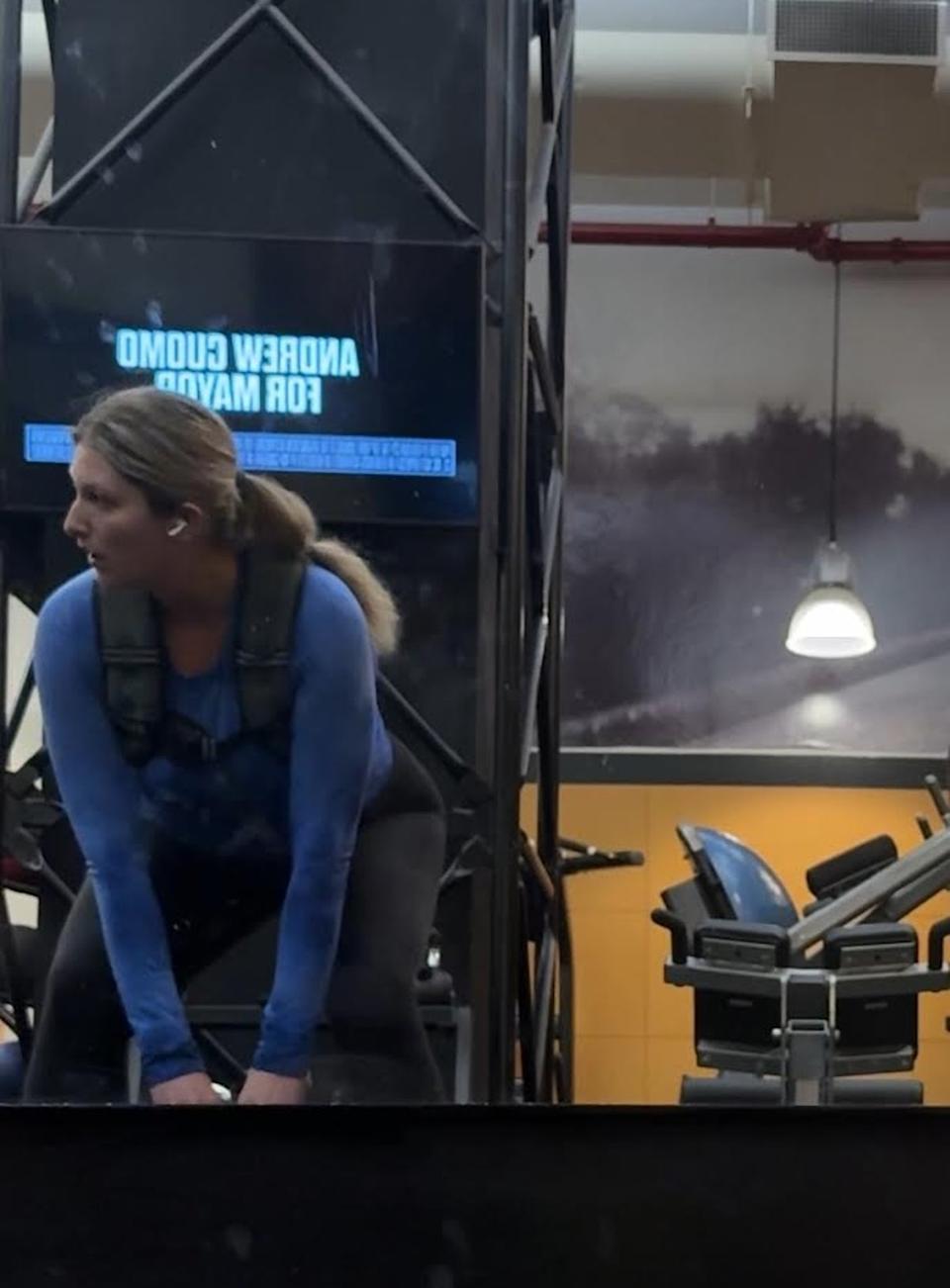 Musto lifts a kettlebell at a gym in New York City while wearing the weighted vest (Julia Musto/The Independent)