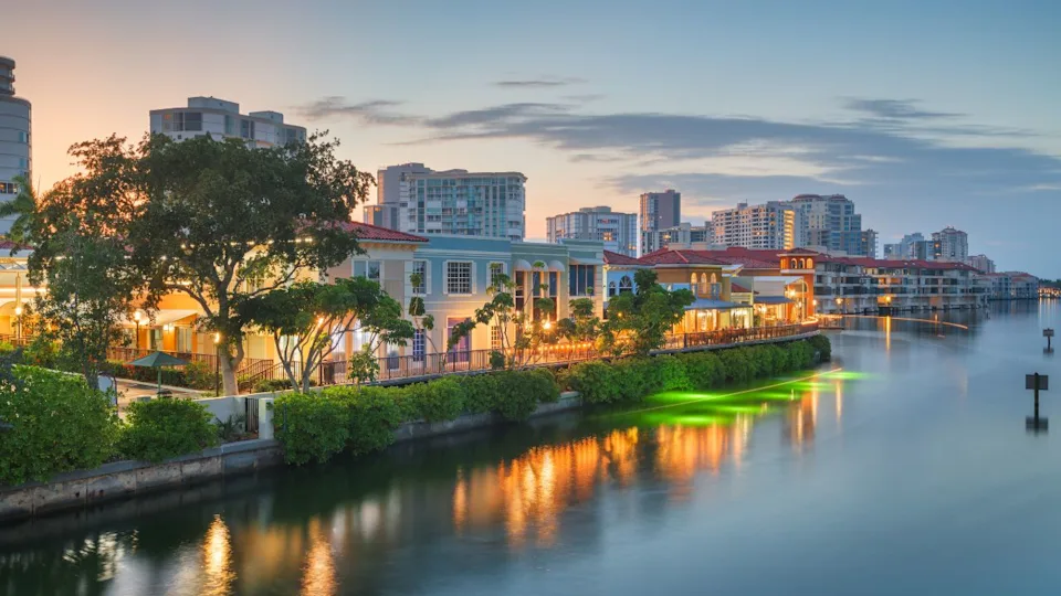 Naples, Florida, USA town skyline on the water at dawn.