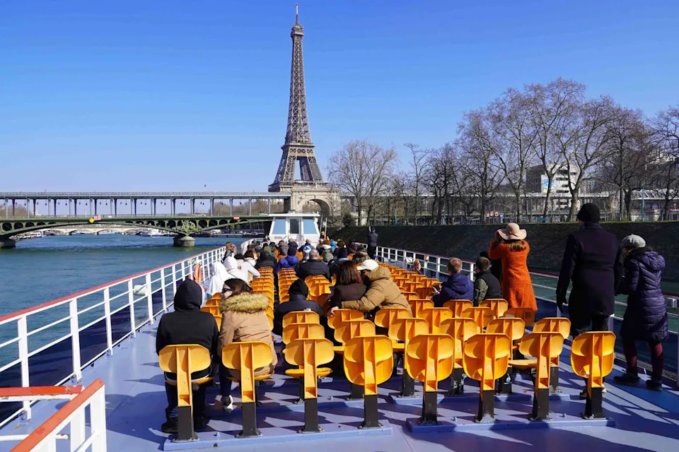 Andia/Universal Images Group/Getty Images A tour boat on the Seine approaches the Bir-Hakeim Bridge, and the Eiffel Tower, in Paris.