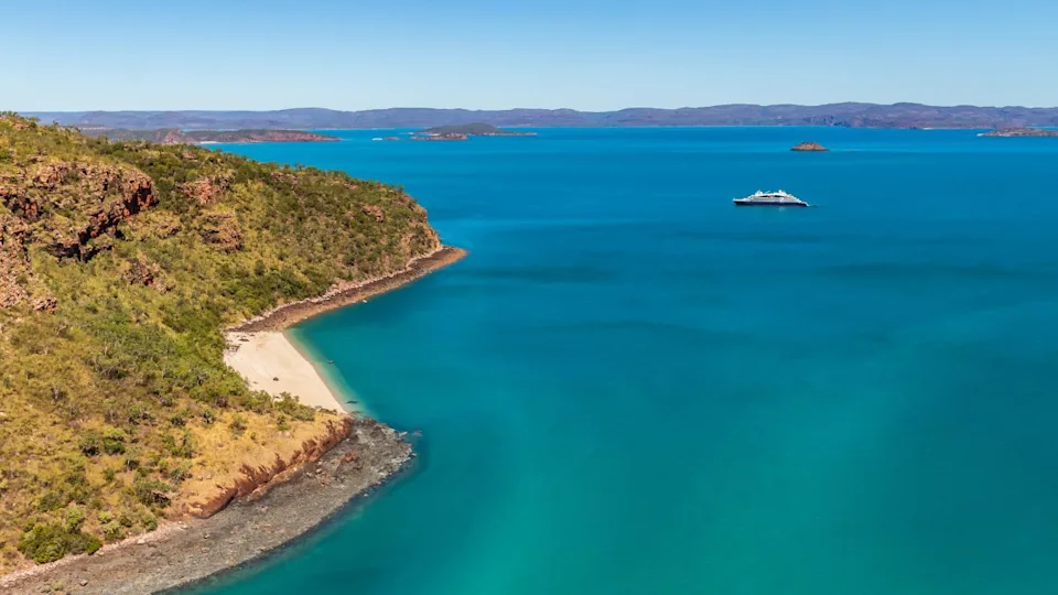 An luxury expedition cruise ship at anchor near Naturalist Island in Prince Frederick Harbor on the remote North West Coast of the Kimberley Region of Western Australia.