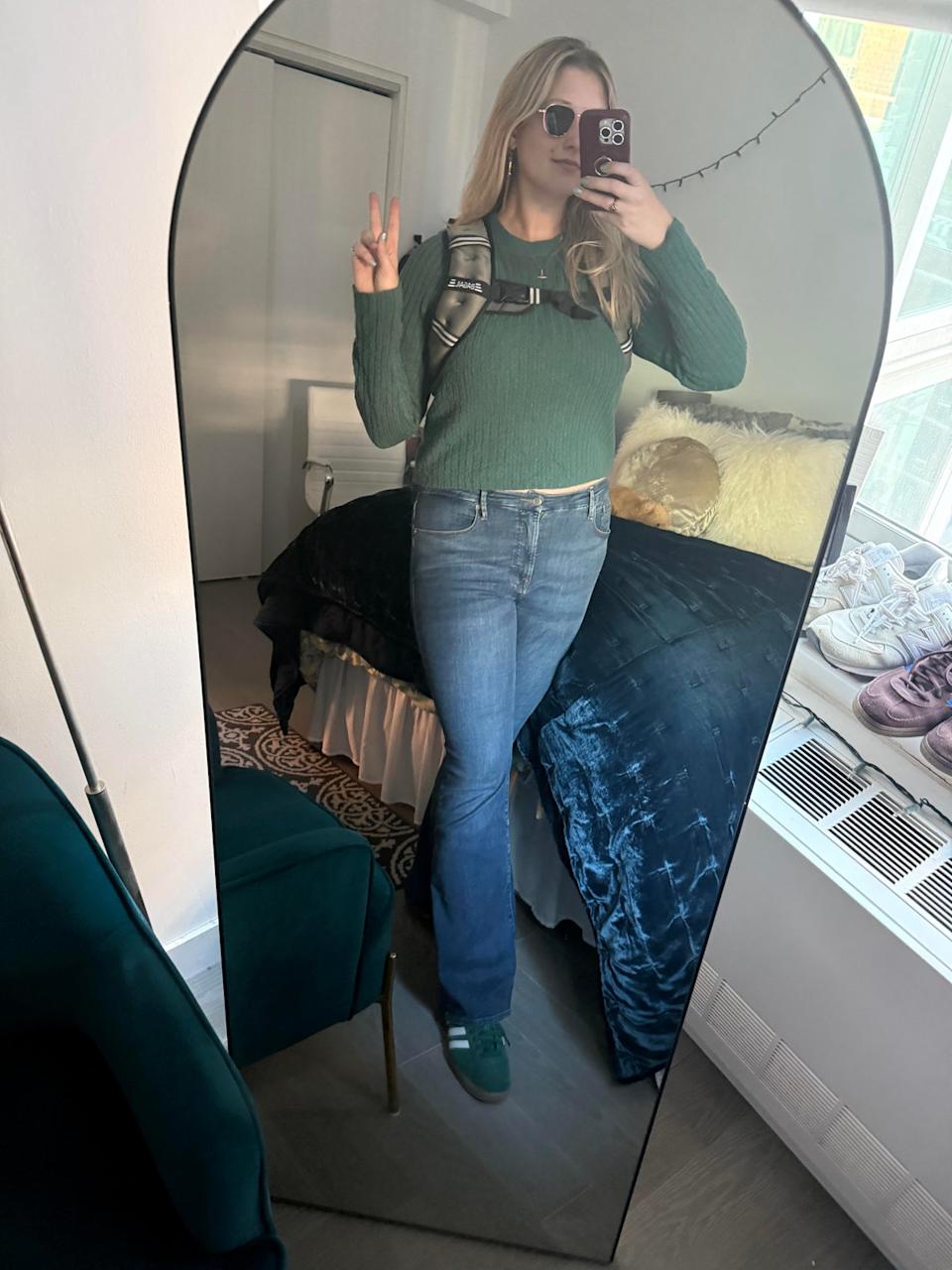 Musto tries on her weighted vest for the first time at her apartment in New York City in October 2025 (Julia Musto/The Independent)