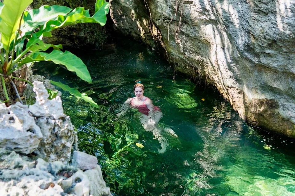 Travel writer Joni Sweet takes a dip in one of the cenotes at  Palmaïa, a vegan resort in Mexico.