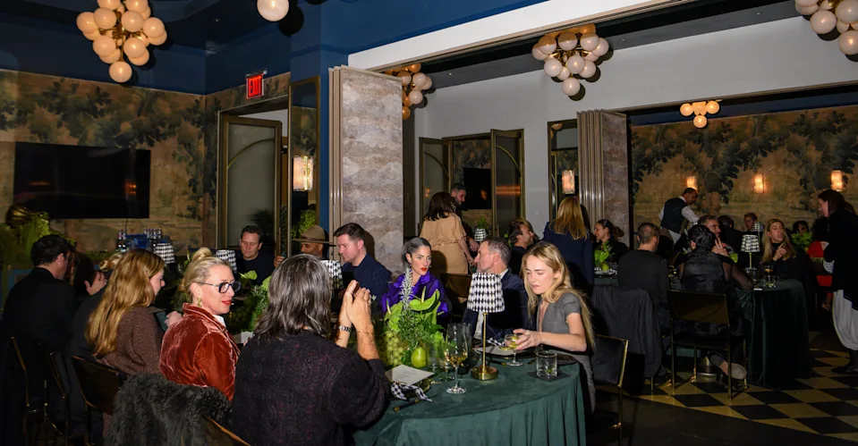 Gathering at a dining venue with guests at round tables.