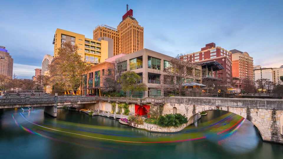 San Antonio, Texas, USA skyline on the river walk at dusk.