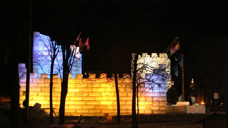 Saranac Lake Winter Carnival's ice palace sculpture lit at night