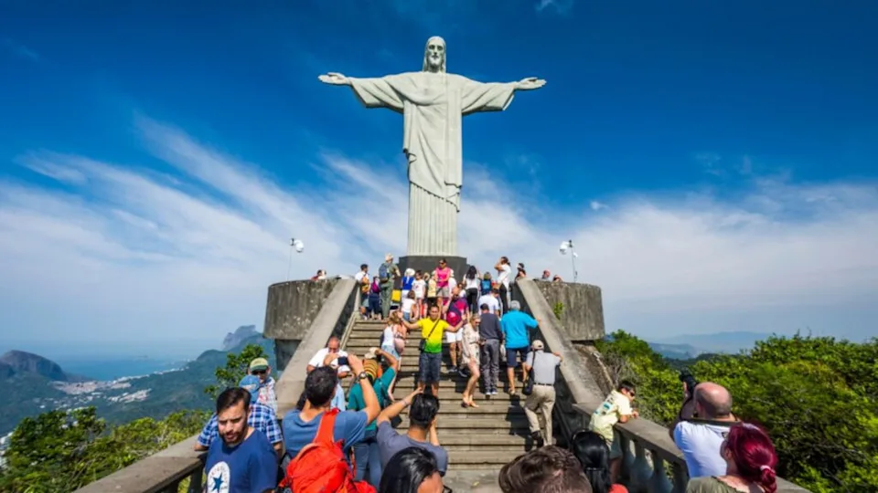 Tourists enjoying Christ the Redeemer statue on top of Corcovado Mountain in Tijuca Forest, Rio de Janeiro, Brazil
