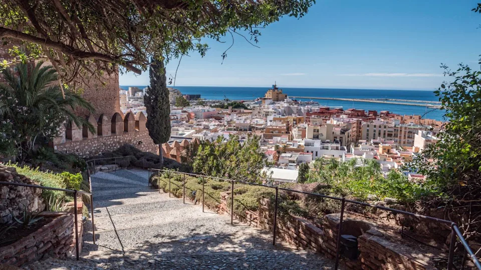 Medieval moorish fortress Alcazaba in Almeria, Access to the fortress with gardens and trees of different species, panoramic view of the city, take in Almeria, Andalusia, Spain