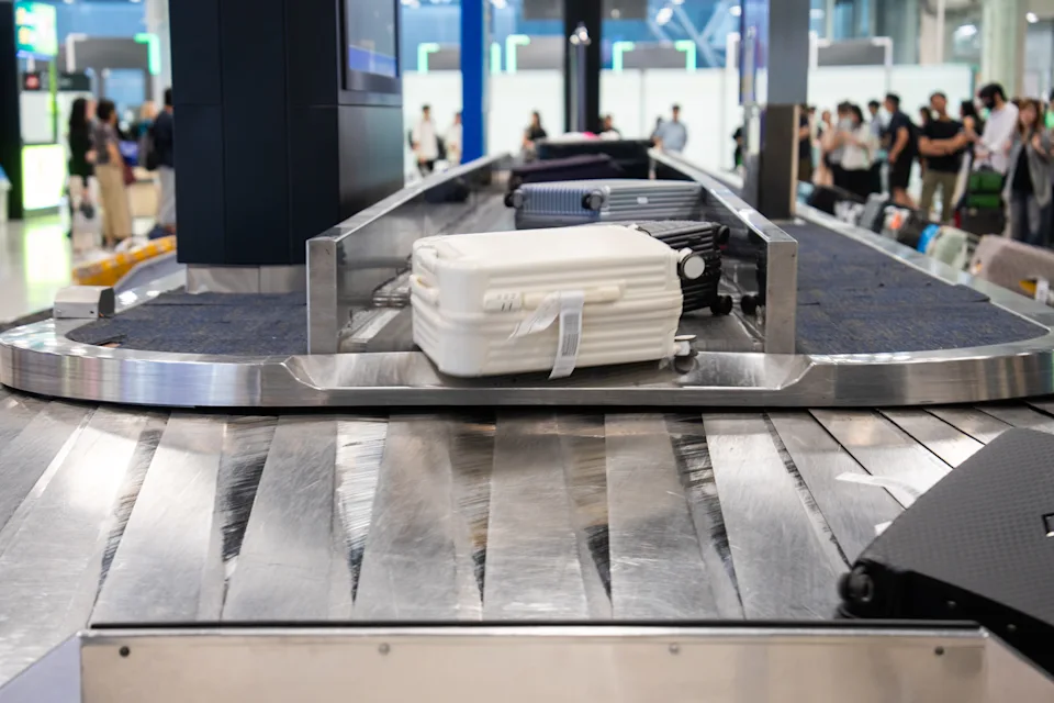 In an international airport, suitcases or baggage are transported along a conveyor belt.