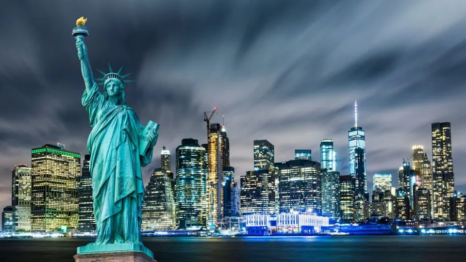 Manhattan panoramic skyline at night. Statue of Liberty with Manhattan background. New York City, USA.